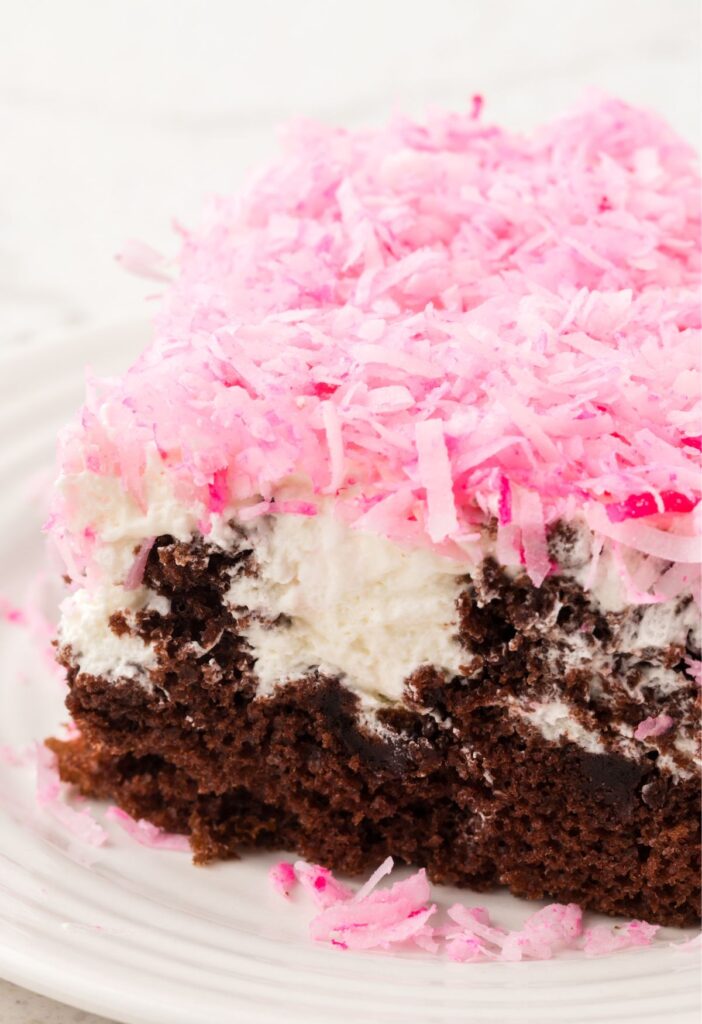 A slice of the poke cake on a white plate