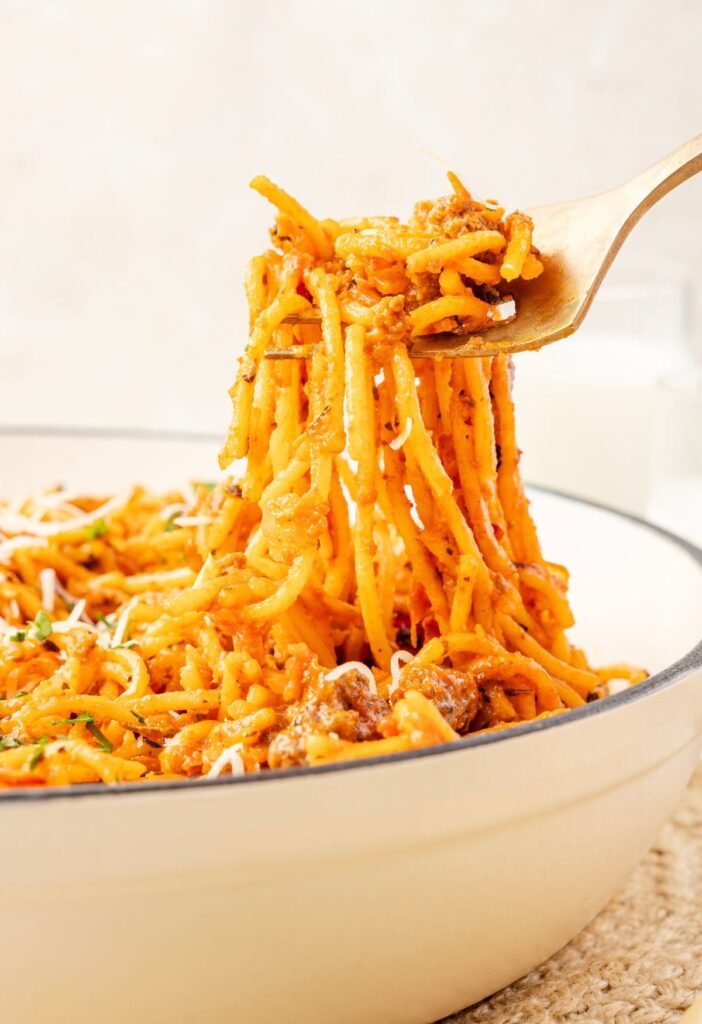 A fork pulling up some spaghetti from the pot