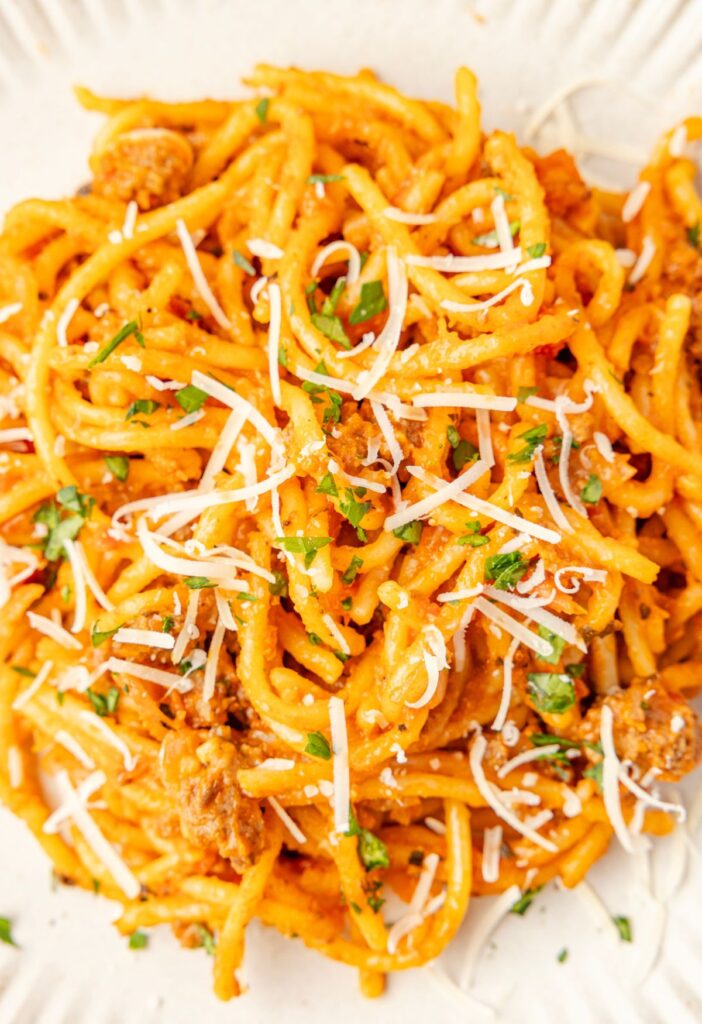 Top view of a serving plate of the spaghetti on a white plate.