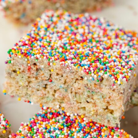 Close up of the sprinkles on top of the dot cake cake batter Rice Krispie treats