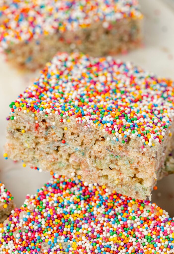 Close up of the sprinkles on top of the dot cake cake batter Rice Krispie treats