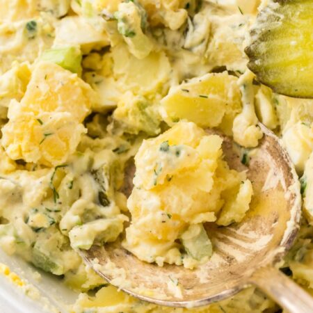A serving bowl of the dill pickle potato salad