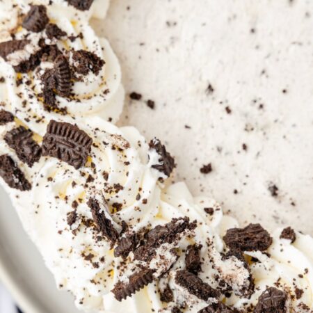 Top view of one side of the Oreo cheesecake with crushed Oreo cookies on it.