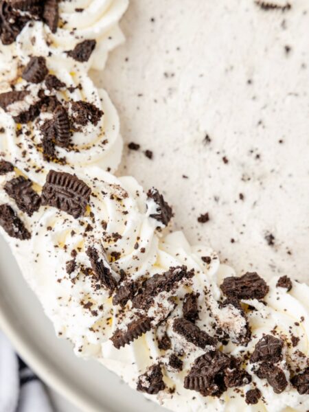 Top view of one side of the Oreo cheesecake with crushed Oreo cookies on it.