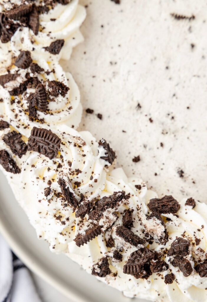 Top view of one side of the Oreo cheesecake with crushed Oreo cookies on it.