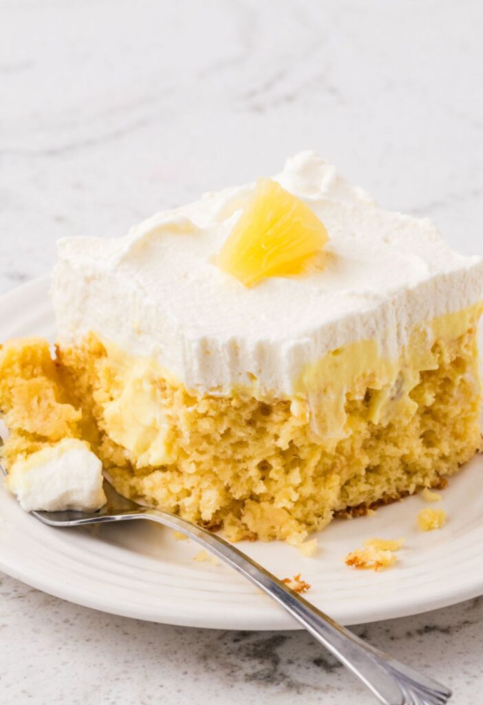 A slice of pineapple cake with a fork