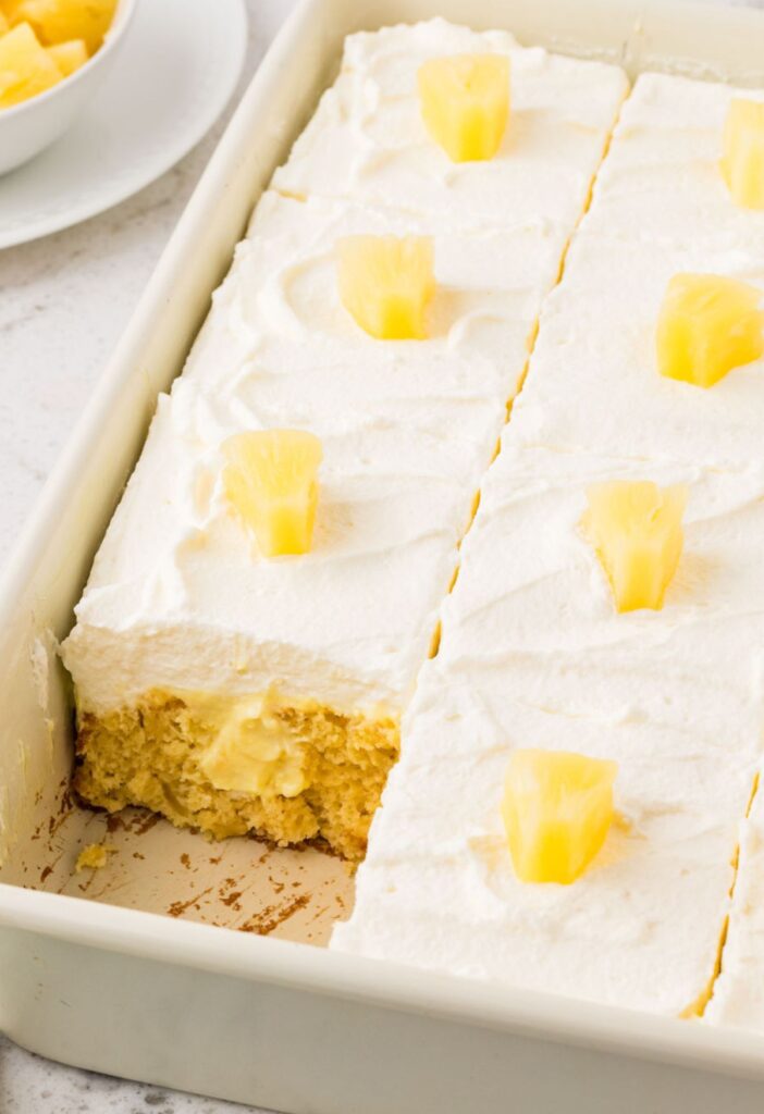A pan of the cake with a piece taken out of it
