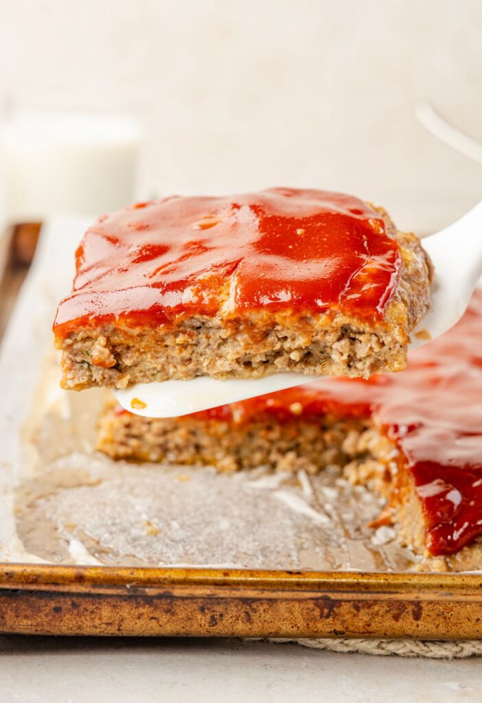 A serving spatula holding a piece of the meatloaf on it