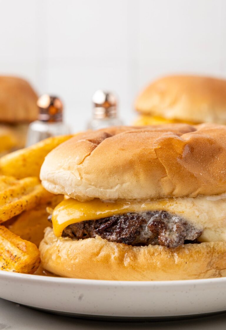 A butter burger with fries next to it on a plate
