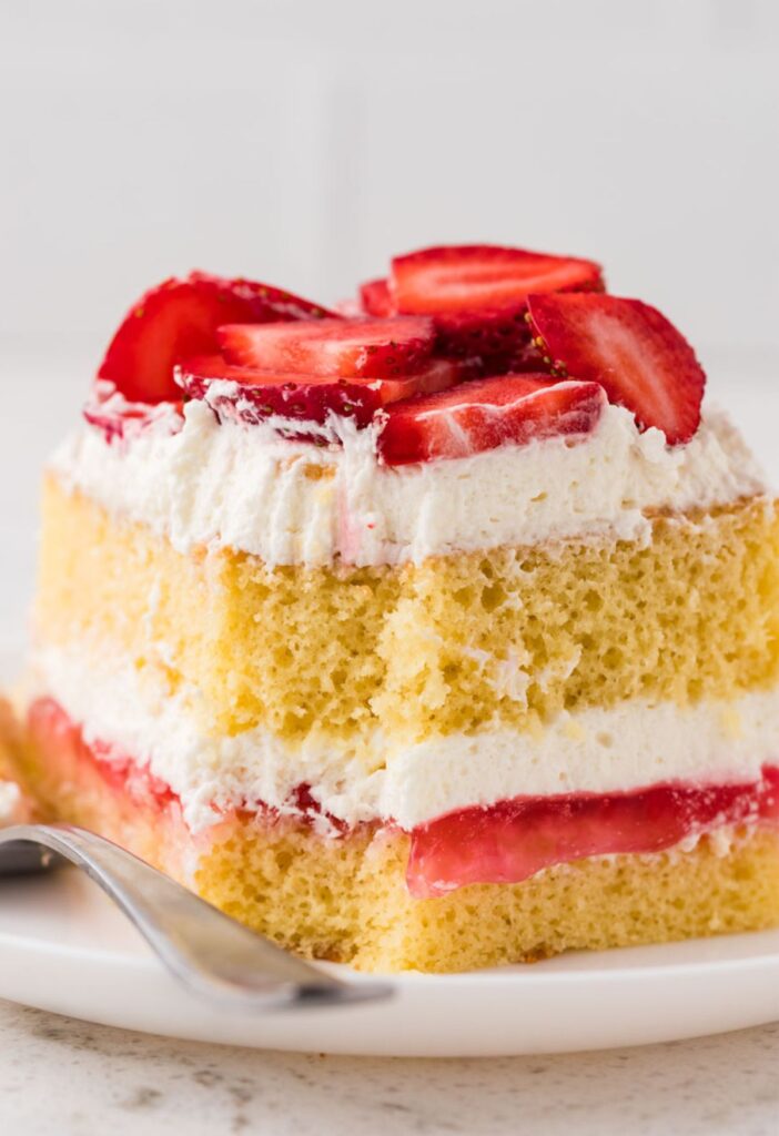 hero shot of a slice of strawberry shortcake sheet cake