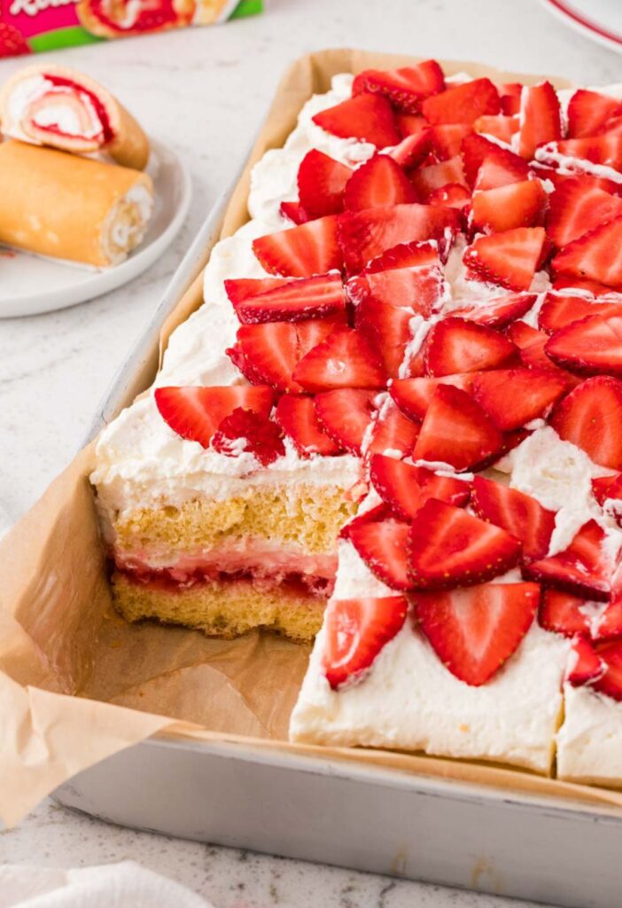 A pan of cake with a piece cut out so you can see the layers.