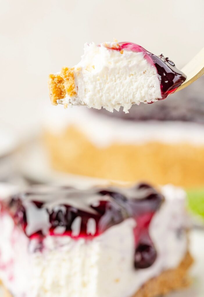 A fork with a bite of the cheesecake on it