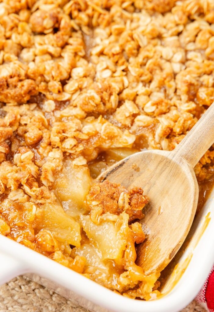 The baking dish with the cooked applesauce crisp inside of it.