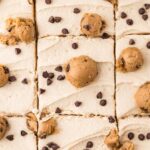Top close up view of the edible cookie dough frosting on top of the chocolate chip cake.