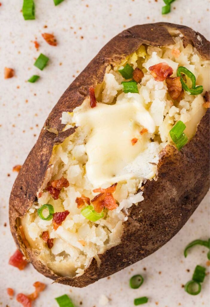 A baked potato on a white plate