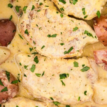Inside the slow cooker with the cooked pork and potatoes.