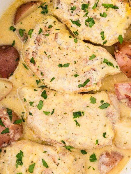 Inside the slow cooker with the cooked pork and potatoes.