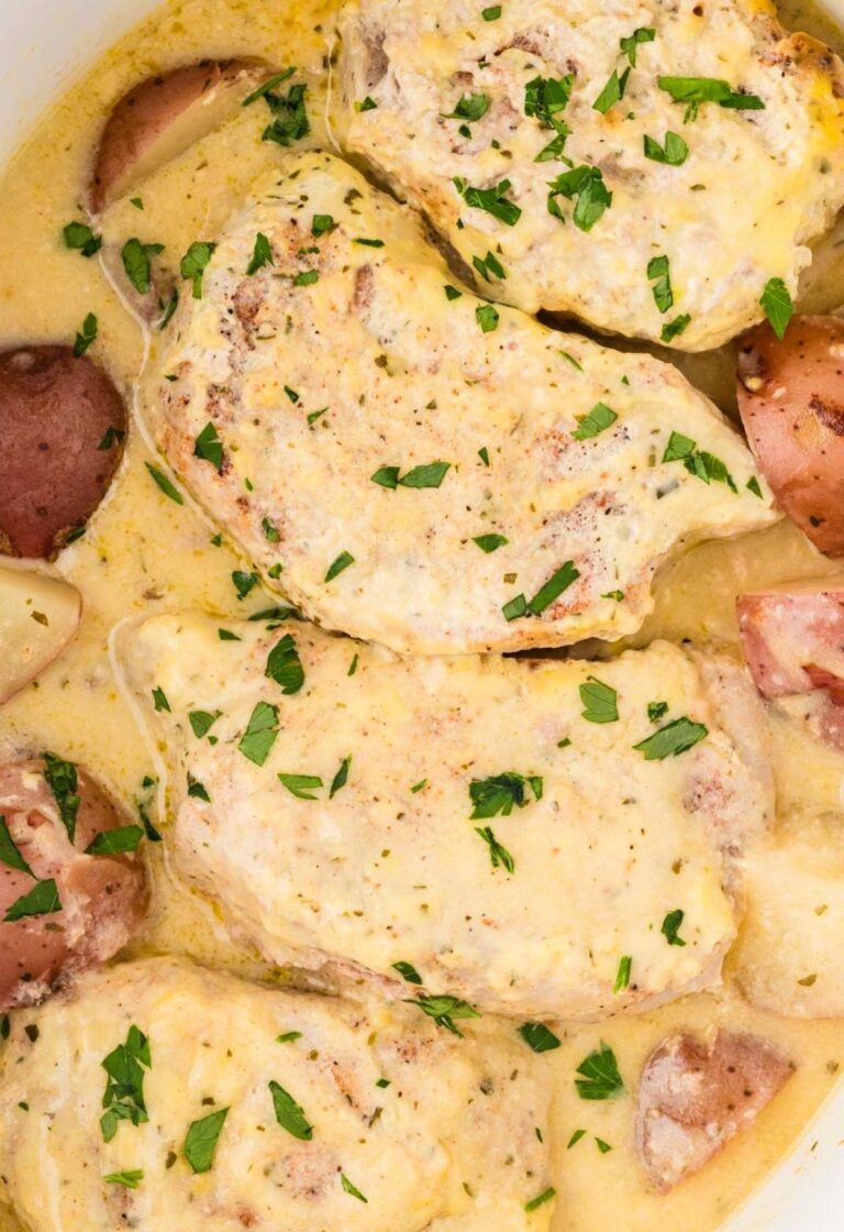 Inside the slow cooker with the cooked pork and potatoes.