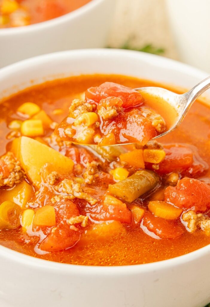 A spoon with a scoop of the soup on it