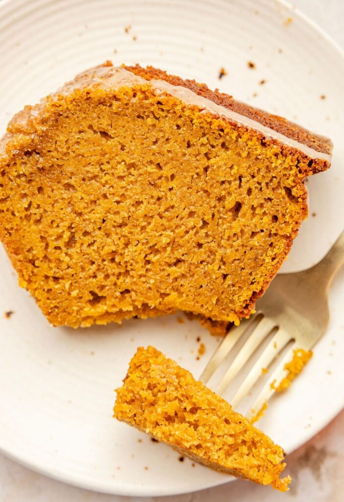 A slice of the pumpkin bundt cake with a fork