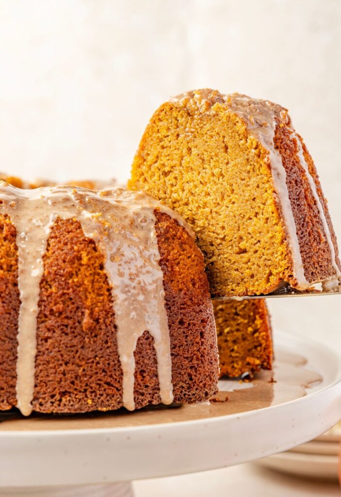 A bundt cake with a slice being taken from it