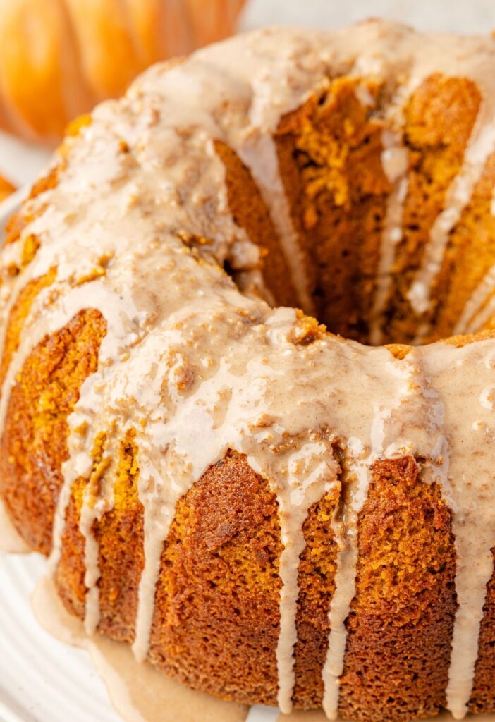 Pumpkin bundt cake ready to serve with a glaze over top.