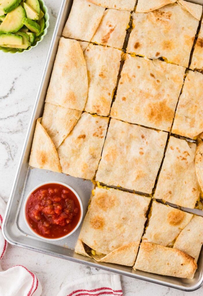 Sheet pan quesadilla with eggs and hash browns in it and sausage.
