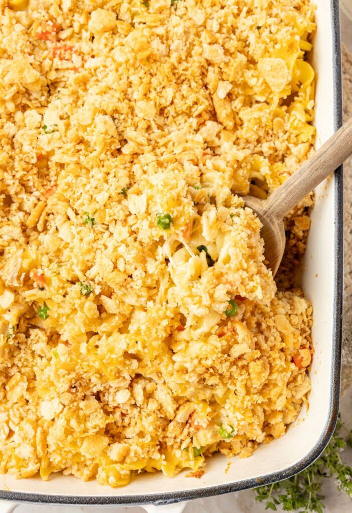 Chicken noodle casserole with egg noodles inside a casserole dish.
