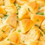 Close up image of the casserole with buttery biscuits on top of it that are golden brown.