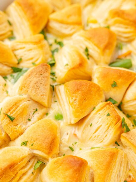 Close up image of the casserole with buttery biscuits on top of it that are golden brown.