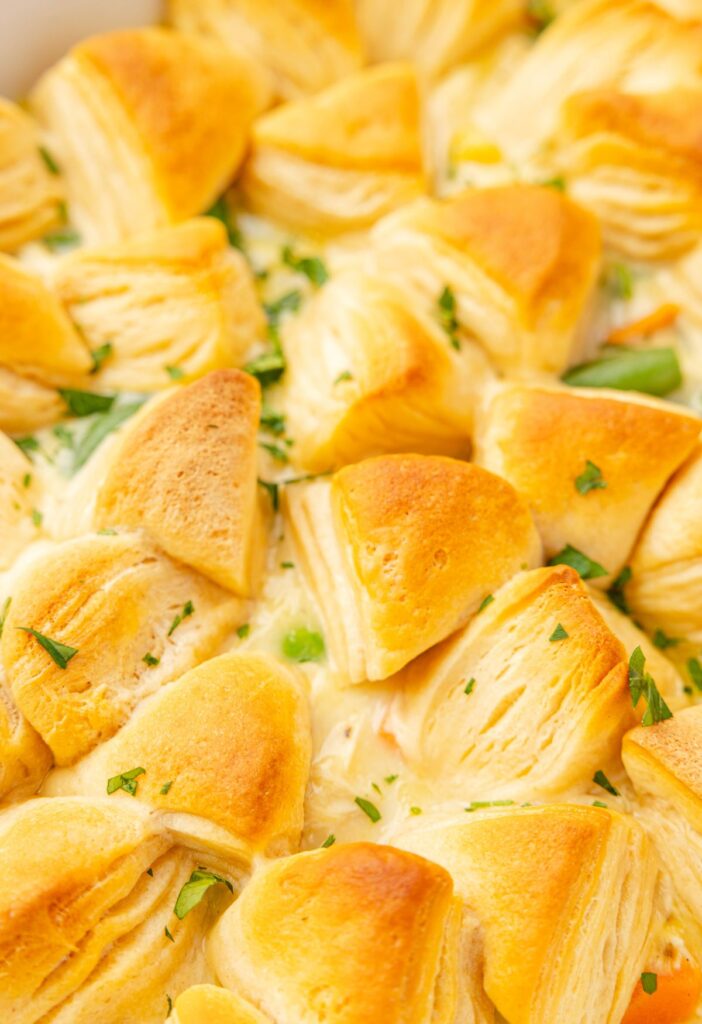 Close up image of the casserole with buttery biscuits on top of it that are golden brown.