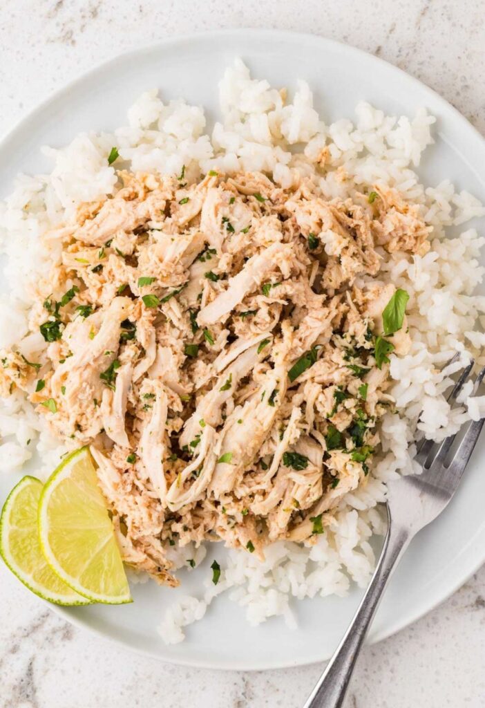 Shredded cilantro lime chicken over a bed of white rice.