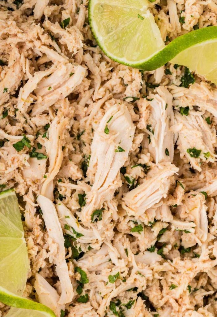 Close up of the cooked shredded chicken with lime and cilantro.