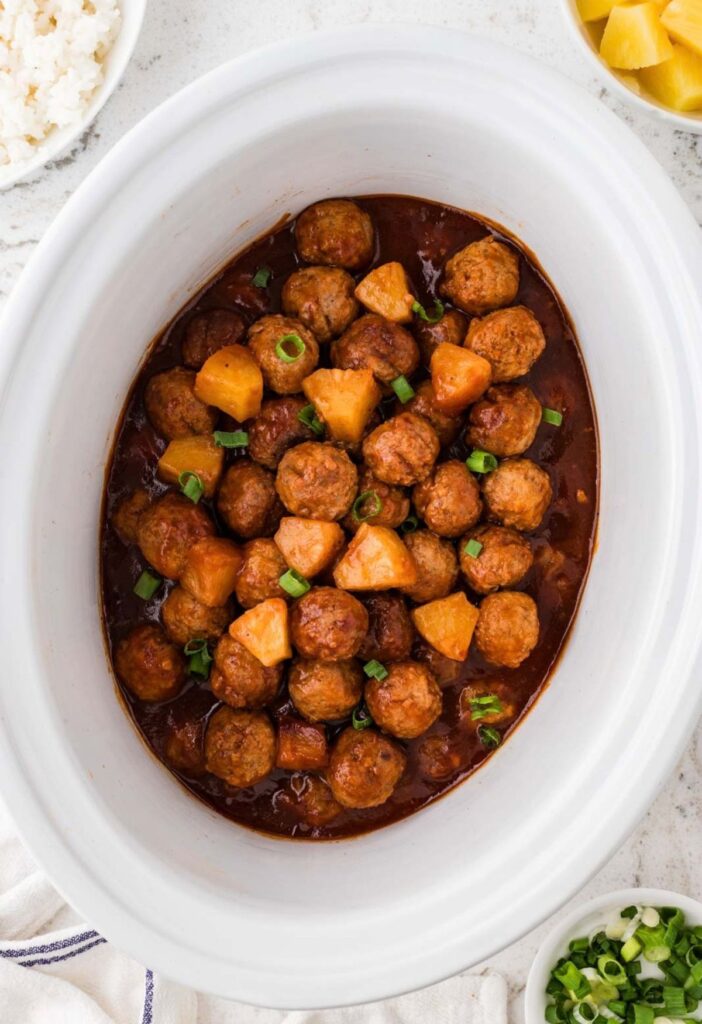 Top view of the crockpot with the meatballs inside of it.