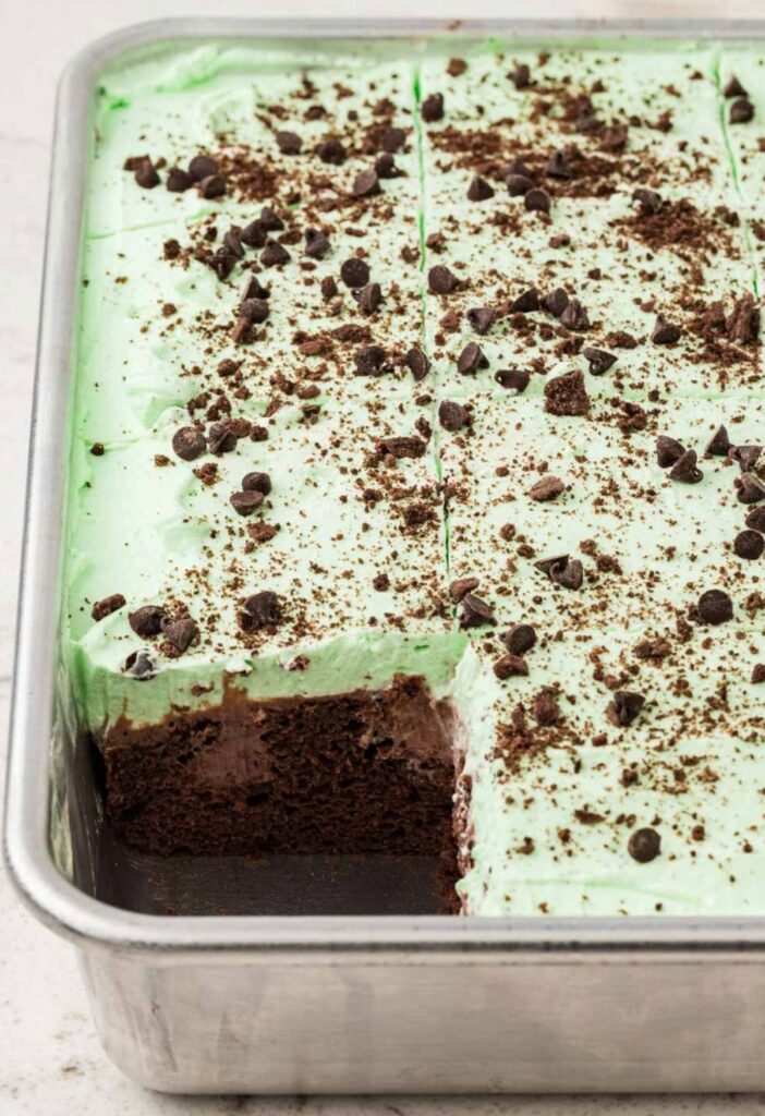 A side view of the cake pan with a piece of cake cut out of it to see the poked middle.