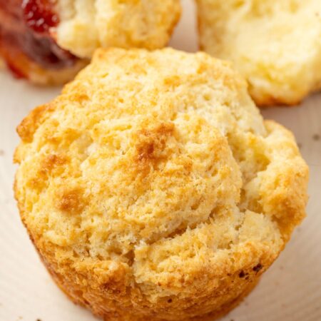 A biscuit sitting on a plate for serving.