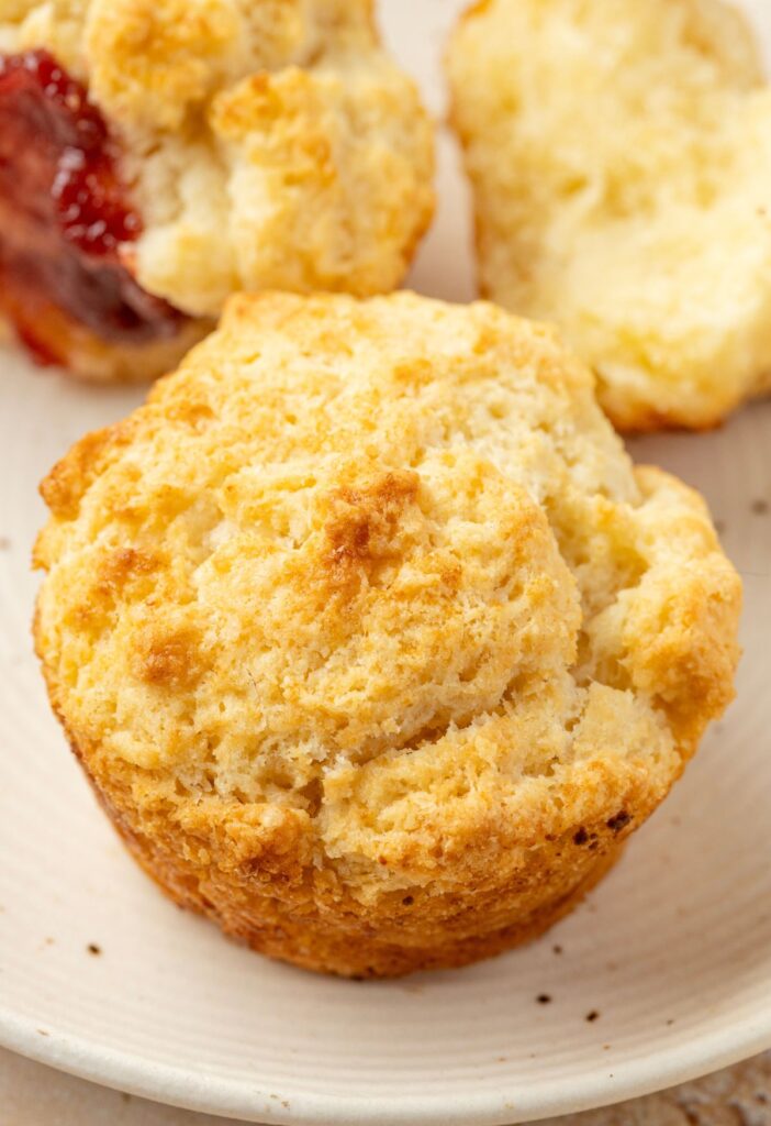 A biscuit sitting on a plate for serving.