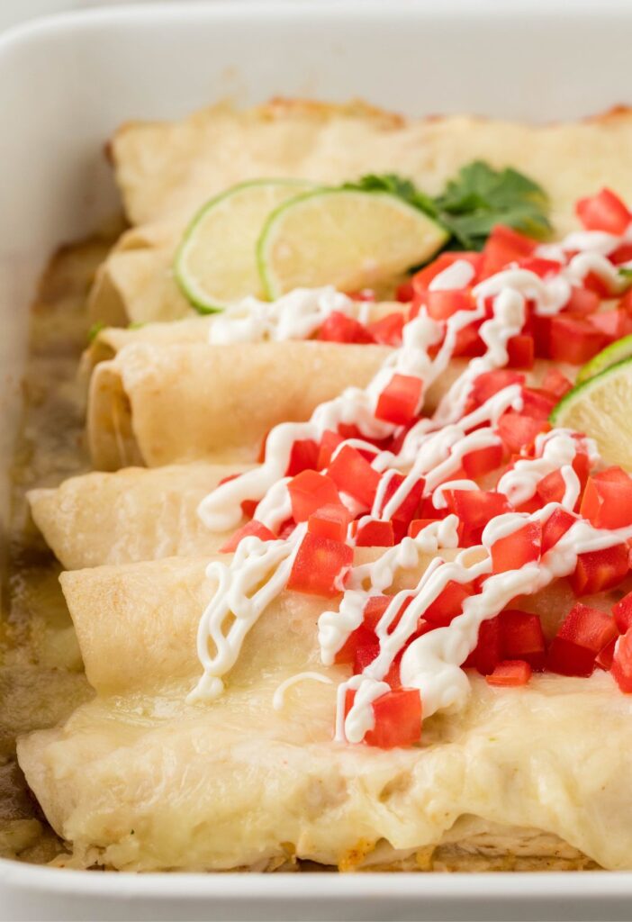 pan of baked chicken enchiladas with honey lime sauce