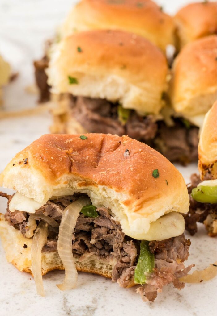 Philly cheesesteak slider with a bite taken out of the front