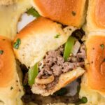 philly cheesesteak sliders, baked and ready to serve with one sideways to see the middle