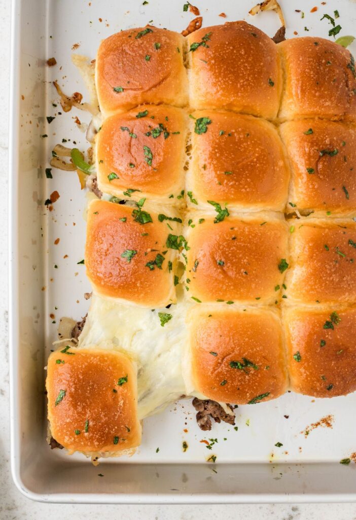 The pan of sliders with philly cheesesteak meat and cheese