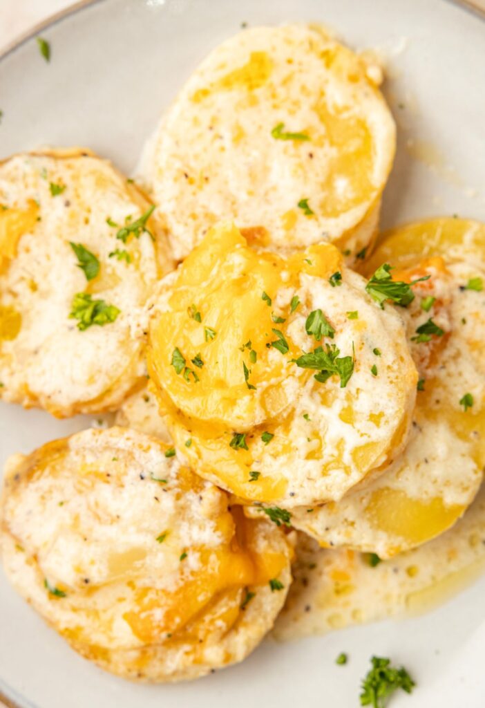 A serving of the scalloped potatoes on a white plate.