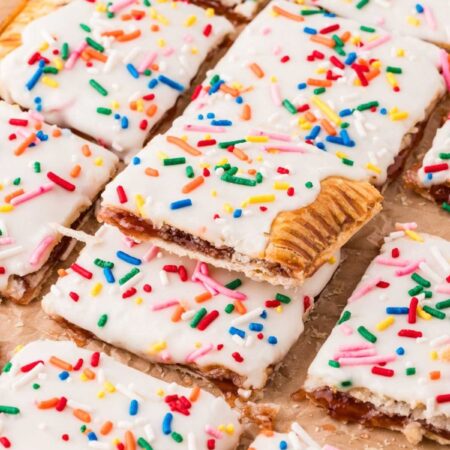 A giant strawberry pop tart with a glaze and frosting.