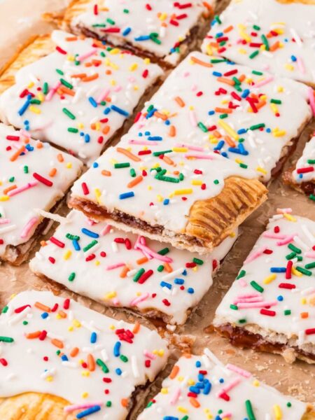 A giant strawberry pop tart with a glaze and frosting.