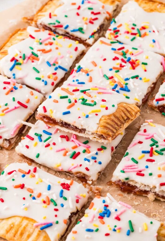 A giant strawberry pop tart with a glaze and frosting.